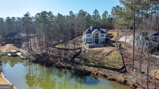 bird's eye view with a water view and a wooded view