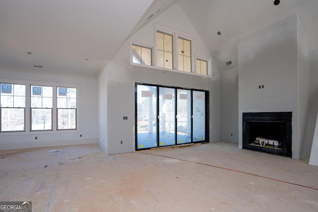 unfurnished living room featuring high vaulted ceiling, a fireplace, and visible vents