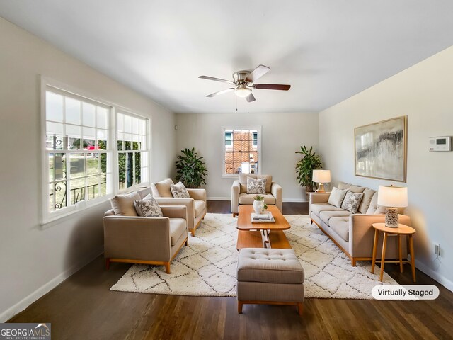 living room featuring ceiling fan, wood finished floors, and baseboards