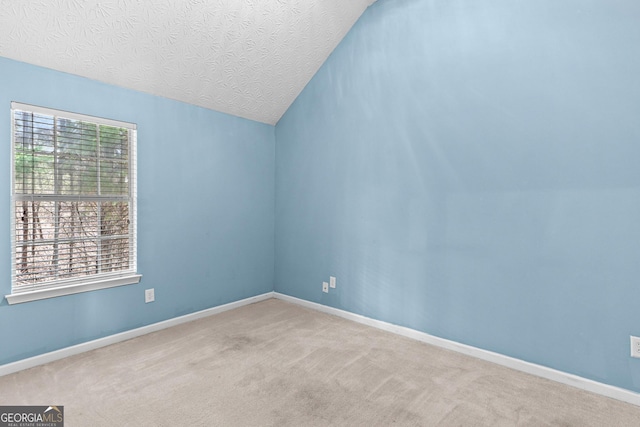 unfurnished room with light carpet, baseboards, and a wealth of natural light