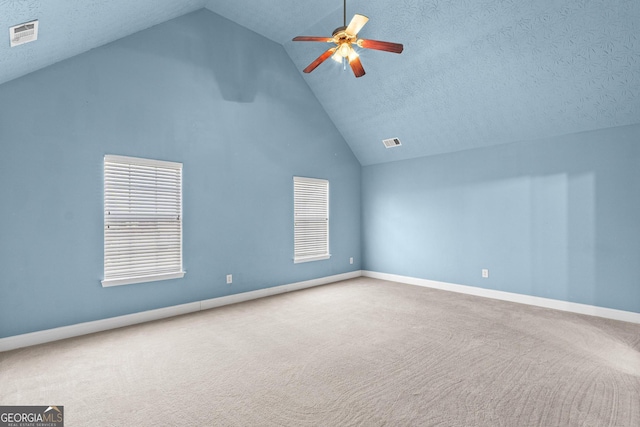 additional living space featuring a textured ceiling, carpet floors, visible vents, and a ceiling fan