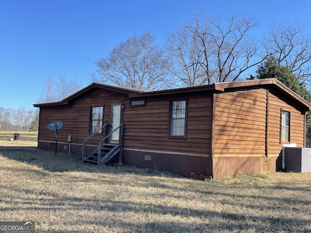 manufactured / mobile home featuring entry steps, central AC, crawl space, and a front yard