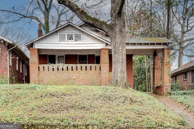 bungalow-style house featuring brick siding