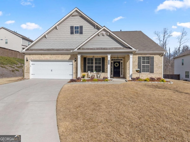 craftsman inspired home featuring brick siding, driveway, and a front lawn