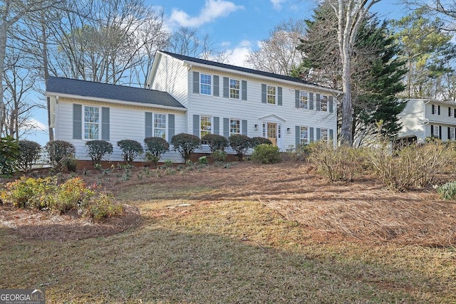 colonial-style house with a front lawn