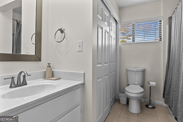 full bathroom with baseboards, toilet, tile patterned flooring, and vanity