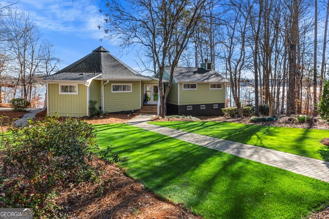 back of property featuring crawl space, a shingled roof, a yard, and central air condition unit