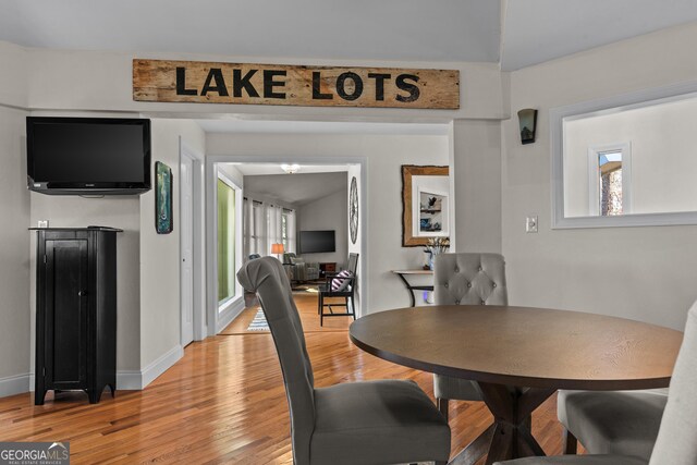 dining area with baseboards and light wood finished floors