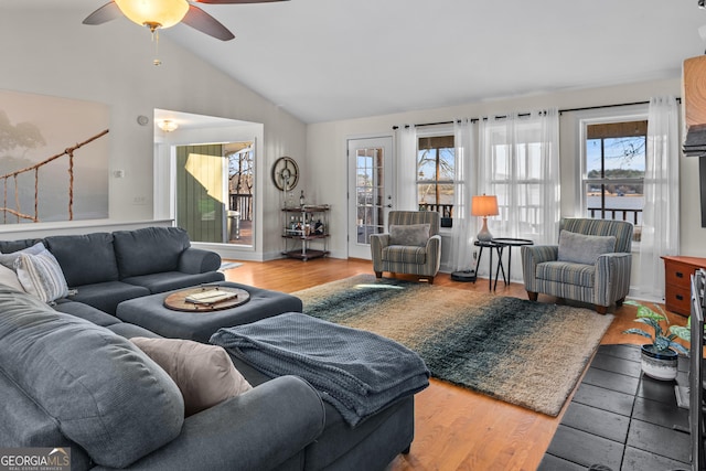 living area featuring plenty of natural light, lofted ceiling, wood finished floors, and ceiling fan