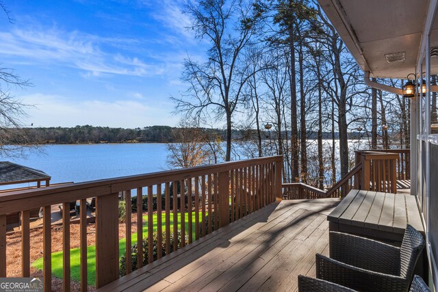 wooden terrace with a water view