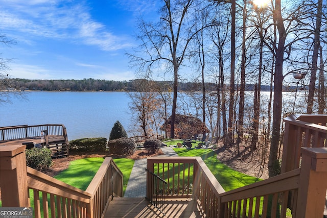 wooden terrace featuring a water view