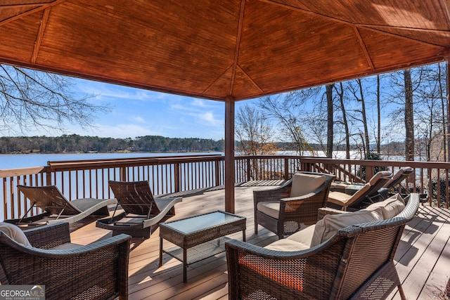 deck featuring a water view, a gazebo, and outdoor lounge area
