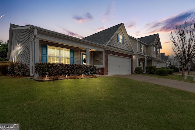 view of front of property with a garage, a yard, concrete driveway, and brick siding