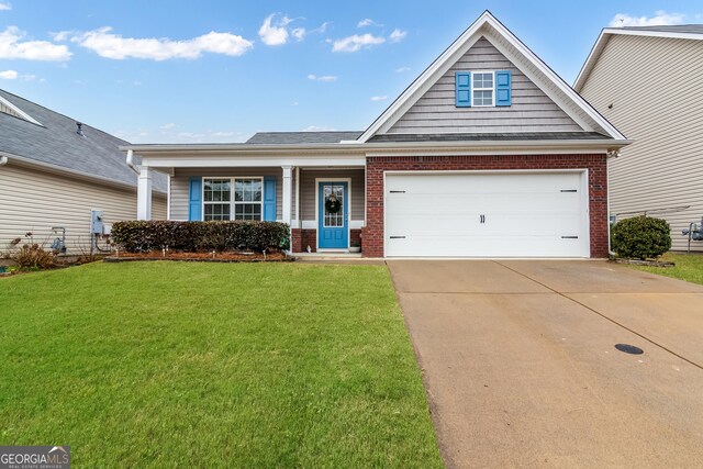 view of front of home featuring a garage, concrete driveway, brick siding, and a front lawn