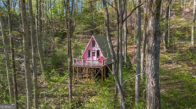 view of outbuilding with a view of trees