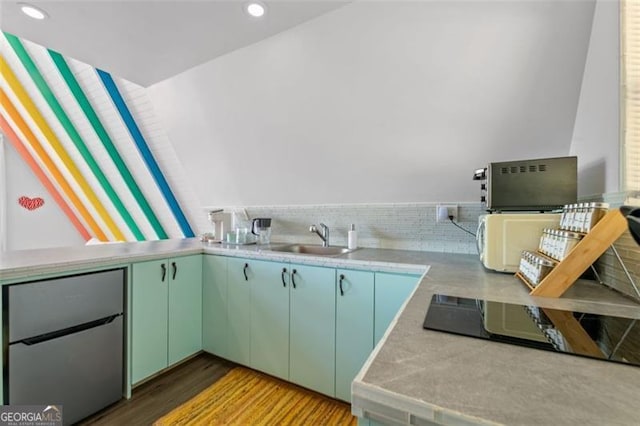 kitchen featuring a sink, light countertops, light wood-style floors, backsplash, and recessed lighting