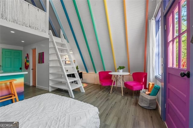 bedroom featuring multiple windows, wood finished floors, and baseboards