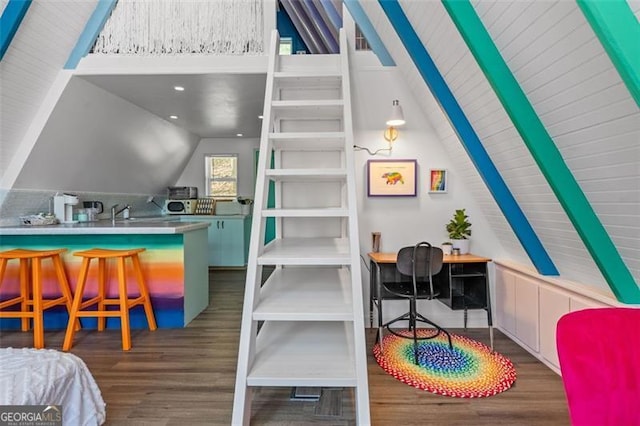 interior space with lofted ceiling and dark wood-type flooring