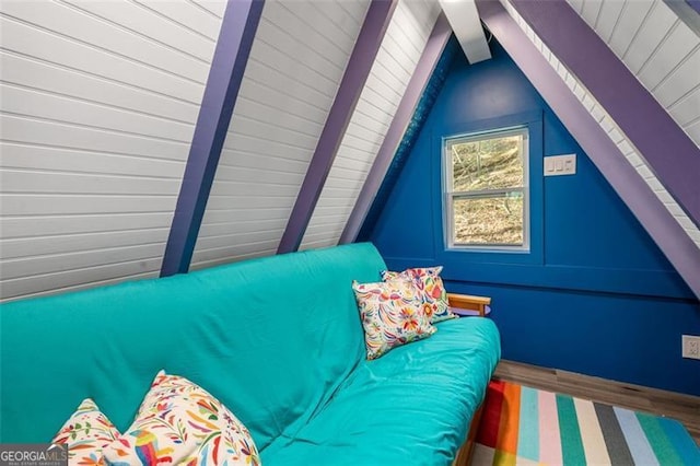 unfurnished bedroom featuring vaulted ceiling with beams and wood finished floors