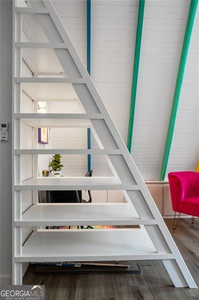 stairway featuring wood finished floors