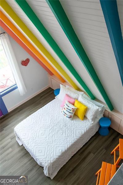 bedroom featuring baseboards and dark wood finished floors