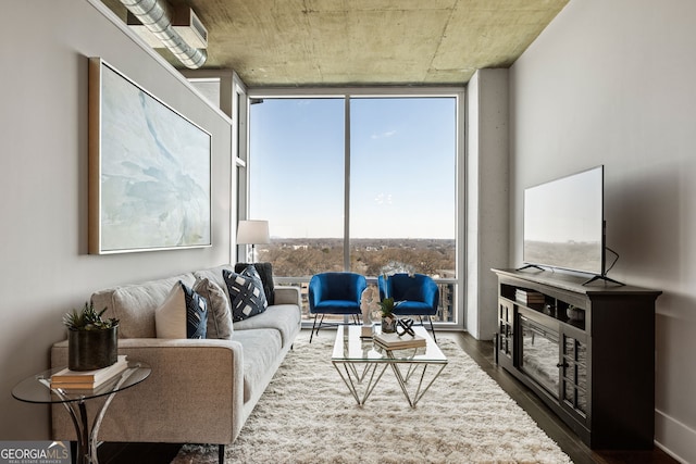 living room with dark wood-style floors and expansive windows