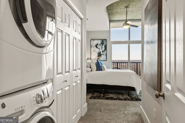 carpeted bedroom with stacked washing maching and dryer