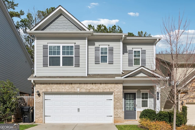 view of front facade with a garage, driveway, brick siding, and fence