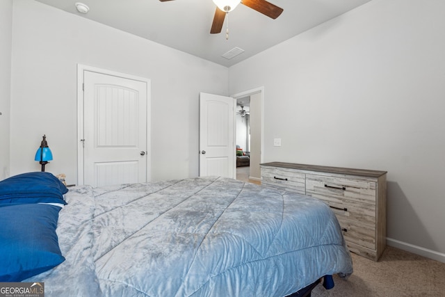 carpeted bedroom with visible vents, a ceiling fan, and baseboards