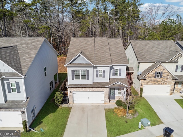 view of front of home with driveway, a front lawn, and an attached garage