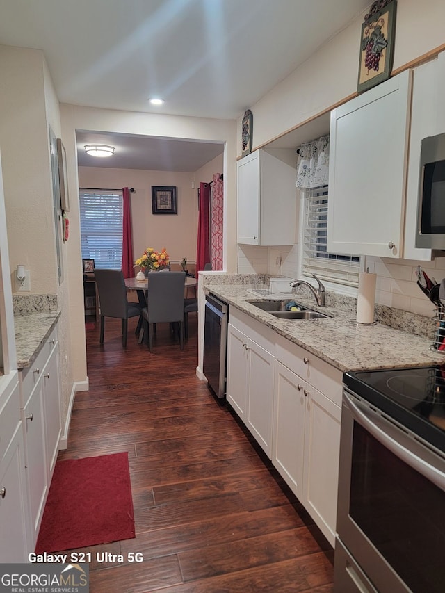2335 Boulder Rd SE, Atlanta, GA 30316 - kitchen featuring light stone countertops, dark wood finished floors, a sink, stainless steel appliances, and white cabinets