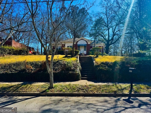 view of front of property featuring stairway