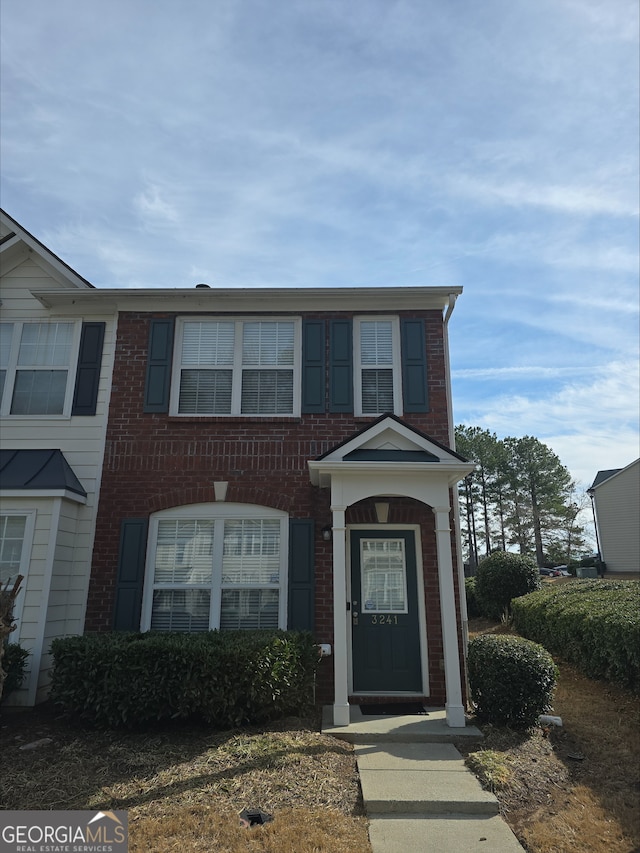 view of property with brick siding