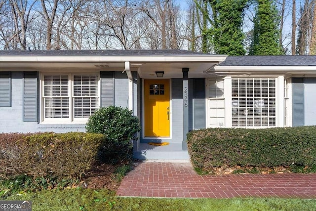 property entrance featuring brick siding