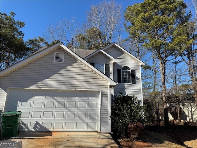 exterior space with driveway and an attached garage