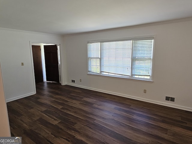 unfurnished room featuring baseboards, crown molding, visible vents, and dark wood-style flooring