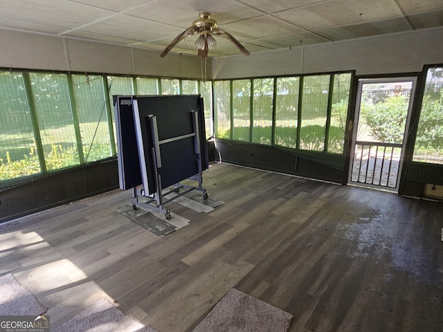 unfurnished sunroom with a ceiling fan