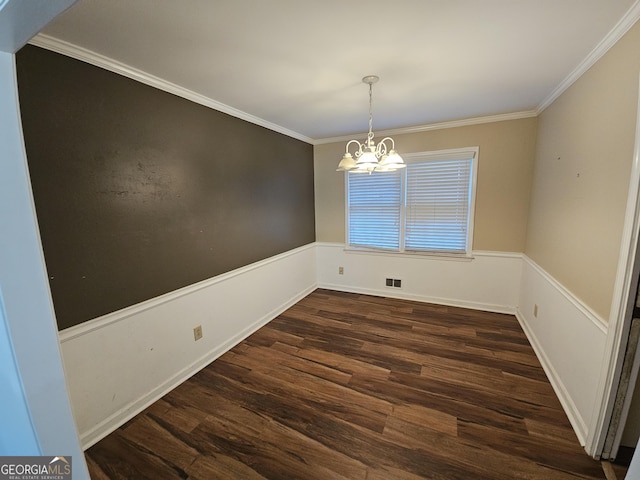 unfurnished dining area with dark wood-style floors, wainscoting, visible vents, and ornamental molding