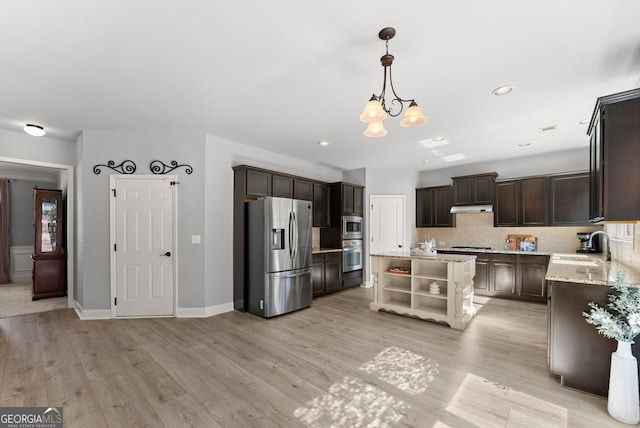 kitchen with appliances with stainless steel finishes, dark brown cabinets, light wood-style floors, open shelves, and a sink