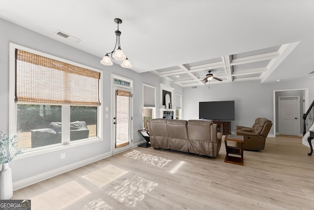 living room with visible vents, a ceiling fan, wood finished floors, coffered ceiling, and baseboards