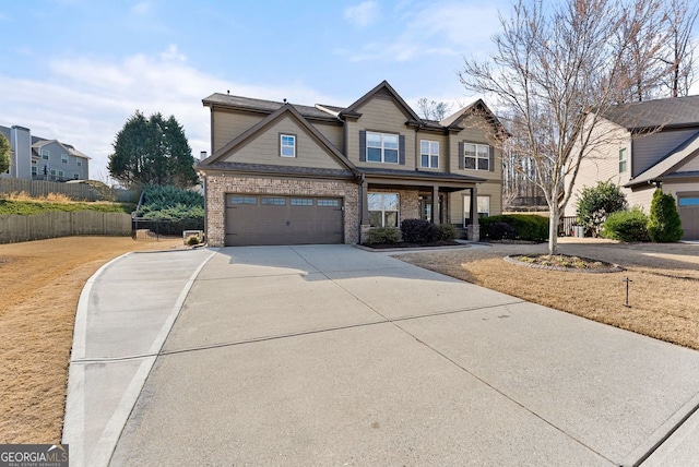 view of front facade with driveway, brick siding, an attached garage, and fence