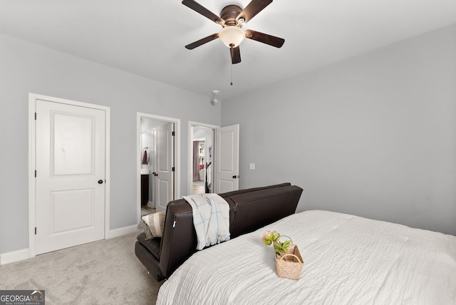 carpeted bedroom with a ceiling fan, baseboards, and connected bathroom