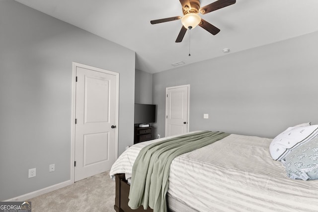 bedroom featuring baseboards, visible vents, ceiling fan, and light colored carpet