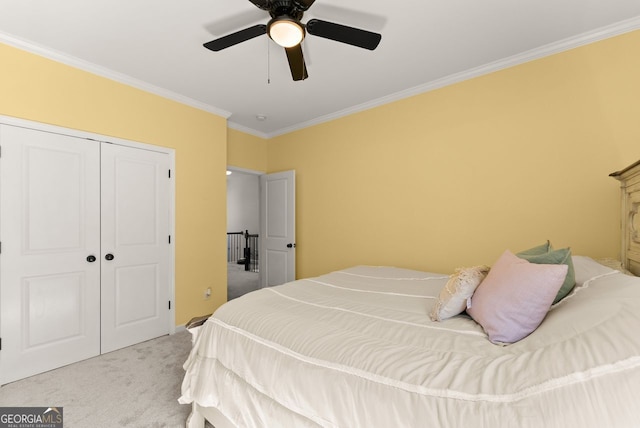 carpeted bedroom with ornamental molding, a closet, and a ceiling fan