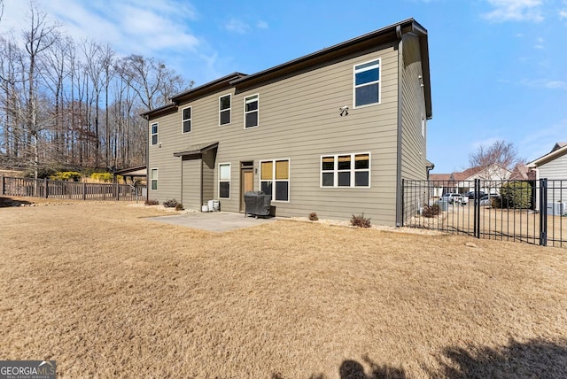 rear view of house featuring a patio area, fence, and a lawn