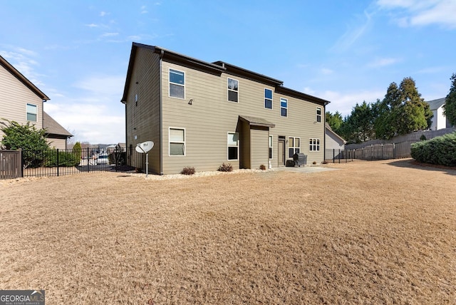 back of property with a patio area, a fenced backyard, and a lawn