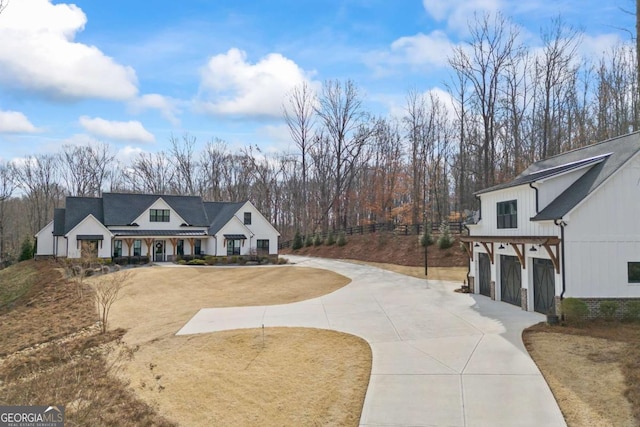 view of front of house with board and batten siding and concrete driveway