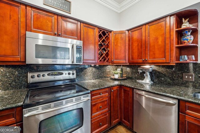3777 Peachtree Rd NE Unit 911, Atlanta, GA 30319 - kitchen featuring crown molding, open shelves, stainless steel appliances, decorative backsplash, and dark stone countertops