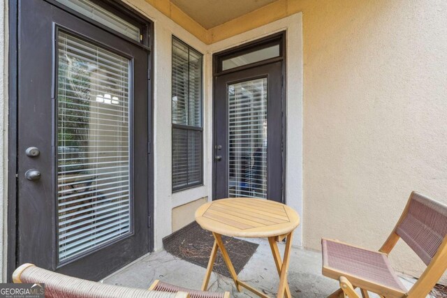 3777 Peachtree Rd NE Unit 911, Atlanta, GA 30319 - property entrance featuring a balcony and stucco siding