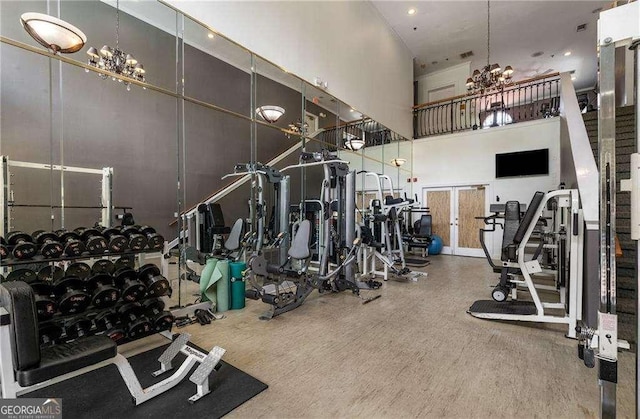3777 Peachtree Rd NE Unit 911, Atlanta, GA 30319 - exercise room with a high ceiling, visible vents, and a notable chandelier